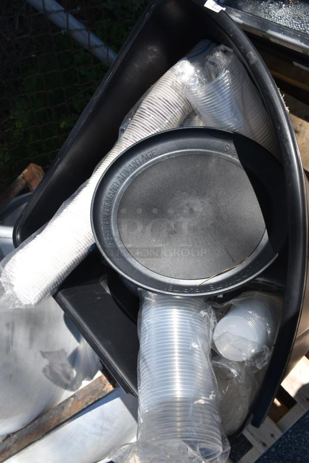 Rooftop mushroom exhaust fan with black poly trash can, includes heat-on-demand label; both items in new condition.