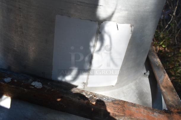 Rooftop mushroom exhaust fan with visible rust on metal base, showing two faded white labels. Suitable for ventilation.
