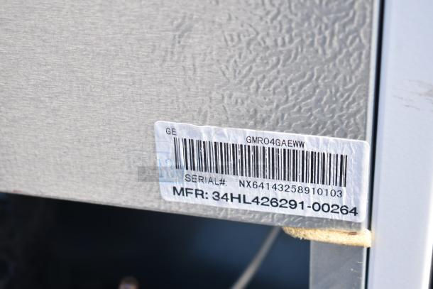 6 assorted mini coolers including Galanz GLR31TS1E02 and Haier models. 115 volts, 1 phase. GE label with serial and MFR numbers visible.