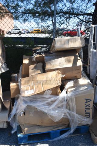 Pallet with unopened, slightly damaged boxes containing assorted items; visible labels include "Axium" and "Made in China".