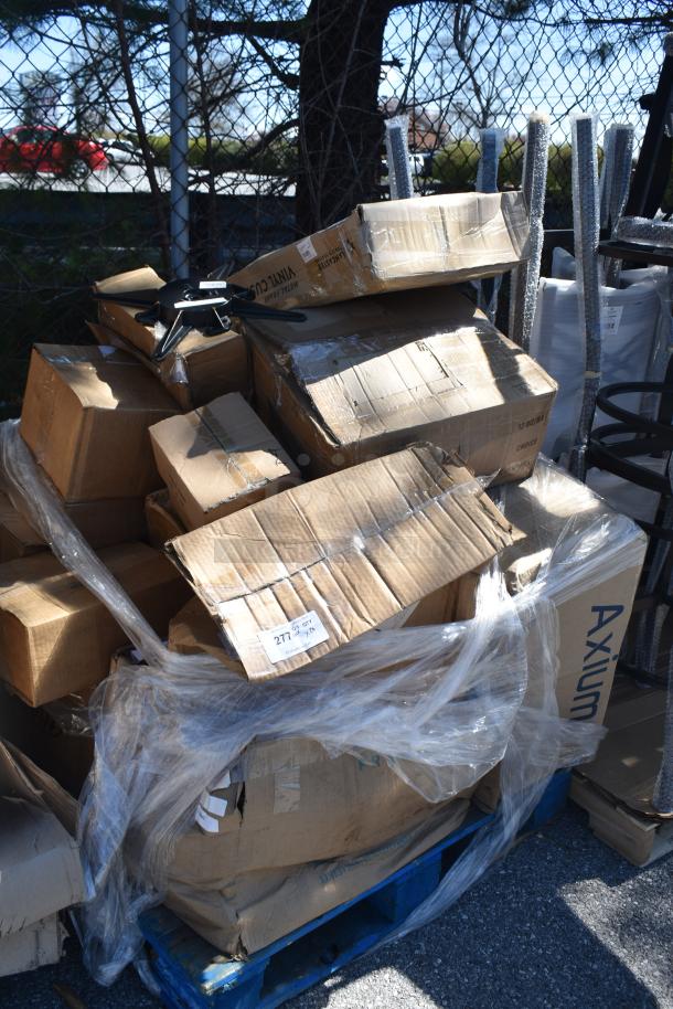 Pallet of assorted boxed items including chair cushions, ceramic jugs, and hotel pans. Some boxes are marked as "Axium."
