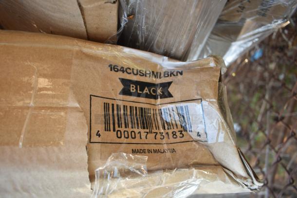 Box labeled "164CUSHMLBKN BLACK" with barcode and "Made in Malaysia," containing chair cushions, scratch and dent condition.