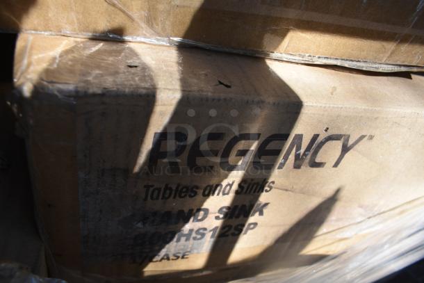 Cardboard box labeled "Regency Tables and Sinks," part of a 20-item auction bundle, scratch and dent condition.