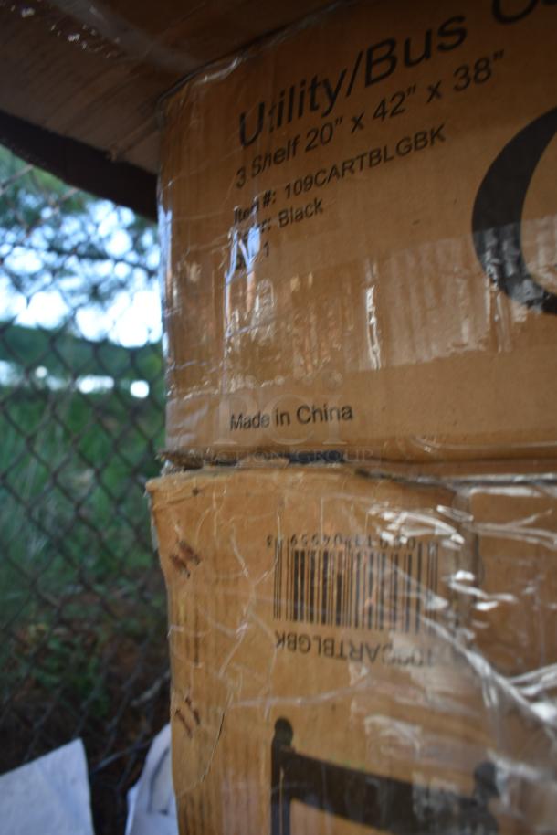 Cardboard boxes showing items including a 3-shelf utility cart. Marked "Made in China", with scratches visible. Item #109CARTBLGBK.