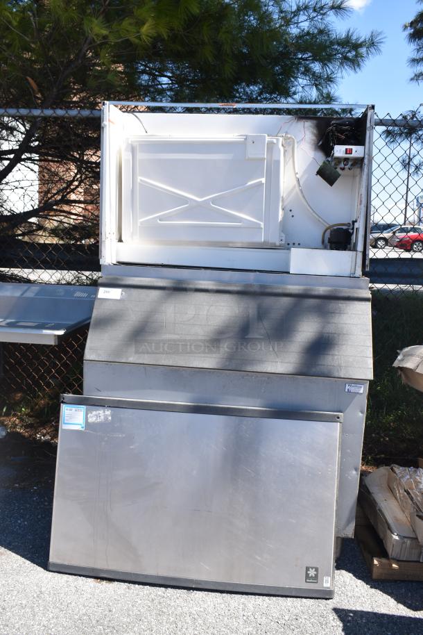 Manitowoc QY1305W commercial ice head on ice bin, 208-230V, 1 phase, stainless steel, outdoor setting, visible wear.