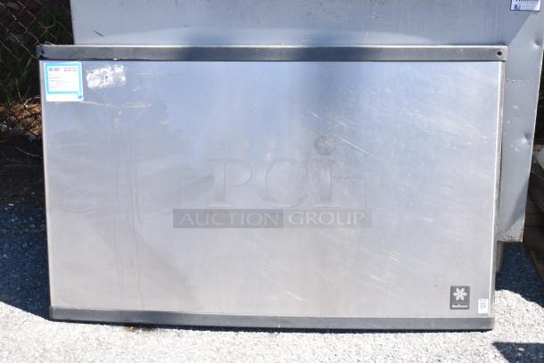 Manitowoc QY1305W commercial ice head on ice bin, 208-230V, 1 Phase. Stainless steel finish, visible label.