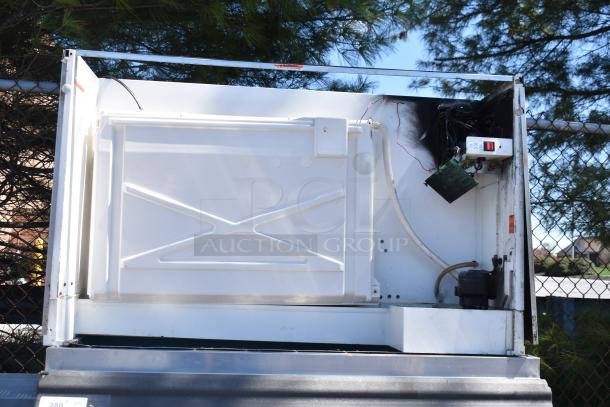 Manitowoc QY1305W commercial ice head on ice bin, 208-230 volts, 1 phase, visible wiring and components.