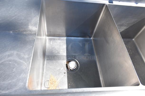 Duke Commercial 3 Bay Sink with dual drain boards, stainless steel, used condition, visible debris in basin.