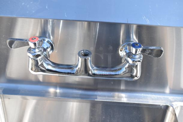 Commercial 3 bay sink with dual drain boards, stainless steel, features chrome hot and cold faucets in good condition.