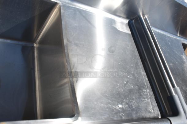 Commercial 3 bay stainless steel sink with dual drain boards, excellent condition, suitable for industrial use.