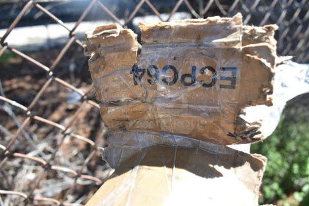 Damaged cardboard box with visible text, "EPC964." Box appears worn and taped, suggesting packaging for auction items.