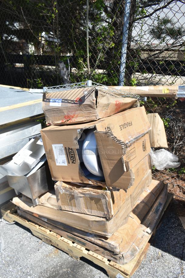 Pallet of 10 new scratch-and-dent items, including Zurn toilet bowl. Damaged boxes, items inside appear intact.