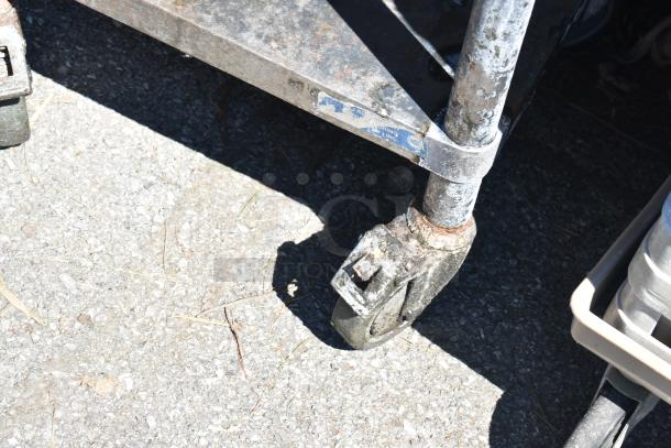 Commercial equipment stand with rusted under shelf and commercial casters, labeled with NSF certification mark.
