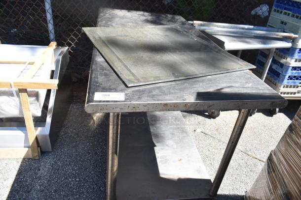 Commercial table with metal under shelf, visible wear and rust on surface, white label indicating item number 288 attached.