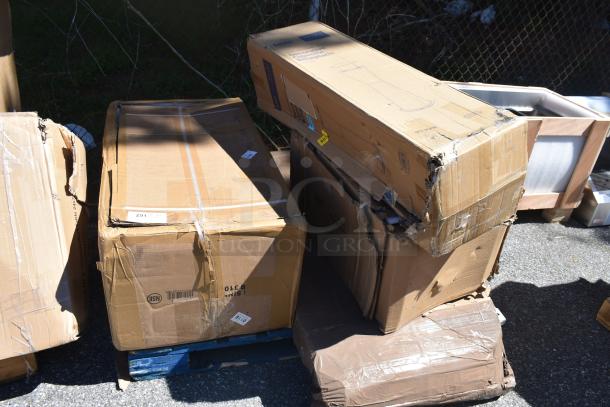 Four brand new items in damaged packaging, including a sink, cigarette receptacle, and grease trap, on a pallet.
