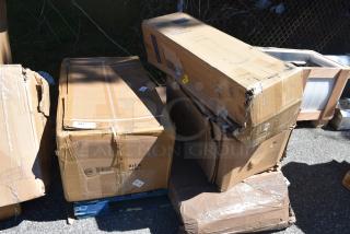 Four brand new items in damaged packaging, including a sink, cigarette receptacle, and grease trap, on a pallet.