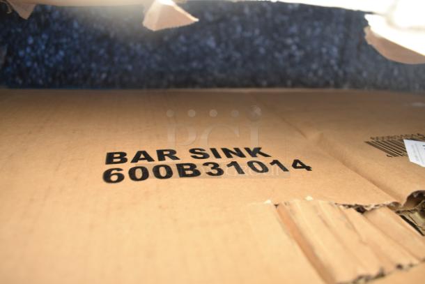 Cardboard box marked "BAR SINK 600B31014," part of a lot with new scratch and dent items including a sink.