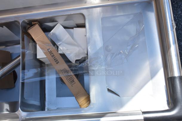 BRAND NEW Regency 39" stainless steel three-compartment corner sink with two drainboards. Model 600S3101410C, scratch and dent condition. No legs.