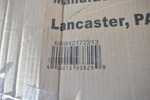 Barcode and text on cardboard box, marked "Lancaster, PA." Box contains assorted scratch and dent items.