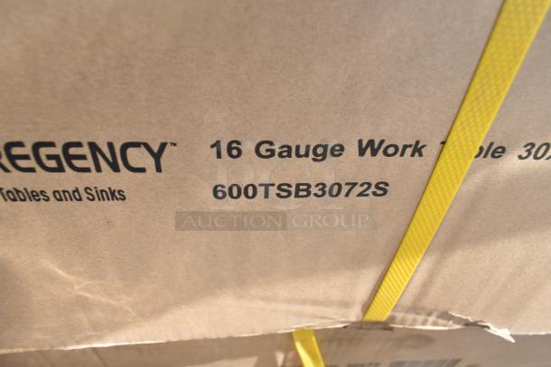 Cardboard box with Regency 16 gauge work table, model 600TSB3072S, labeled. Yellow straps visible.