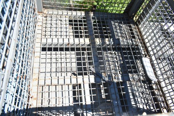 Rusty wire cage with a grid pattern, showing signs of weathering. Sturdy construction, suitable for storage or transport.