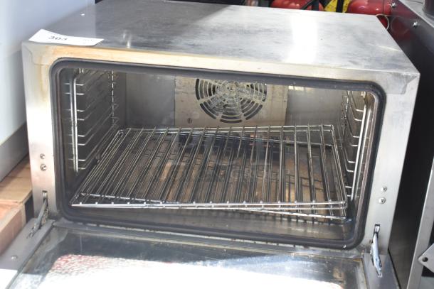Brand new Avantco 177CO16 half-size countertop convection oven, 1.5 cu. ft., 120V, visible scratches/dents; interior racks shown.