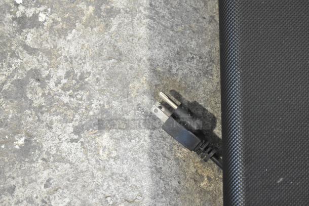 Alt text: Close-up of LifePro PacerMini Portable Treadmill power cord and textured surface, 110V, 1 Phase.