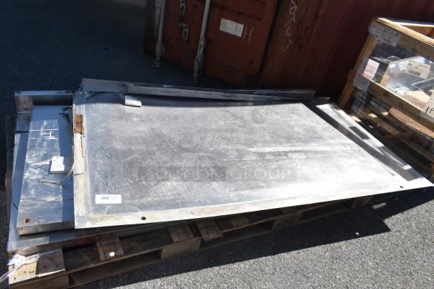 Three metal panels on wooden pallets, showing signs of wear. Includes label "308," indicating auction item.