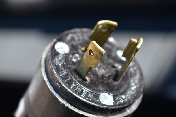 Close-up of electrical plug labeled "NEMA" for Hussmann Commercial Horizontal Grab N Go Merchandiser, 115/208-230 Volts.