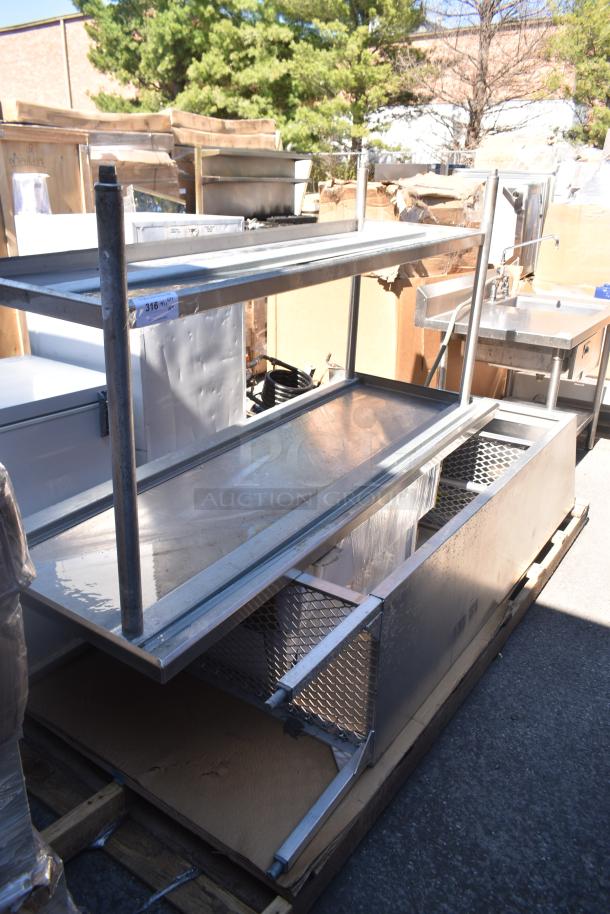 Metal table and cabinet with mesh sides in an outdoor setting, labeled "316" for auction. Visible wear, sturdy construction.