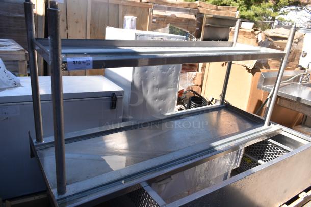 Metal shelving unit in a lot with a table and cabinet, visible label indicates auction item number 316.