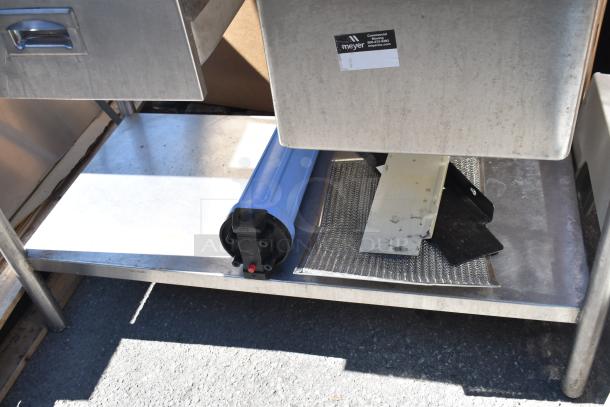 Commercial counter with a sink bay, drawer, and visible label from Meyer. Stainless steel, in used condition.