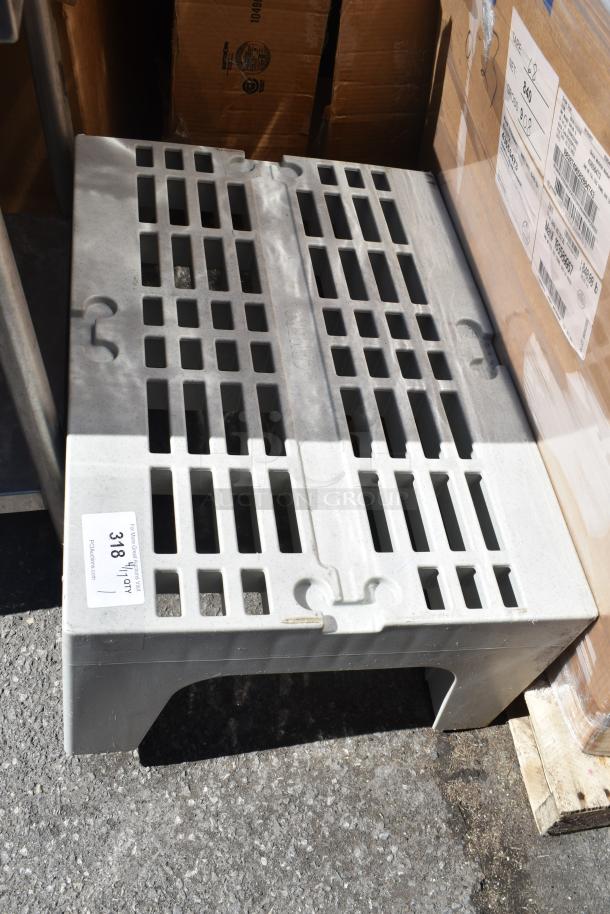 Gray poly dunnage rack with vented surface, sturdy design. Visible auction tag indicates item number 318.