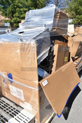 Cardboard boxes wrapped in plastic, containing brand new scratch and dent items. Visible labels indicate additional parts.