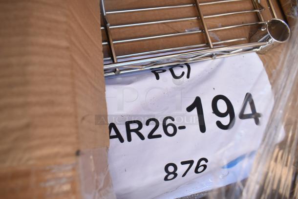 10 brand new scratch and dent items in packaging, including tabletop, shelf. Marked 'MAR26-194'.