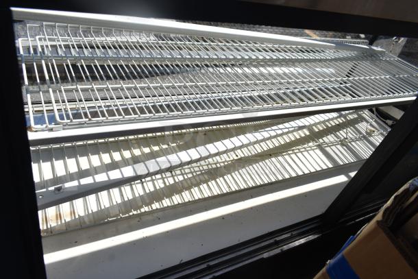 True TCGD-77 commercial dry display case, features multiple wire shelves, 115V, 1 phase. Clean condition, ideal for merchandising.