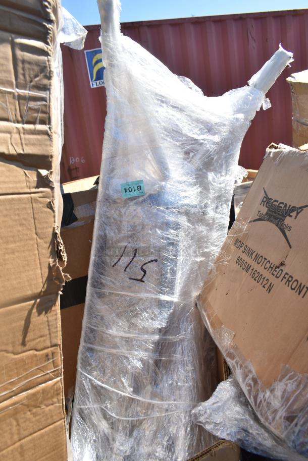 6 new scratch and dent items, including a mop sink and ban rack, wrapped in plastic. Regency box visible.