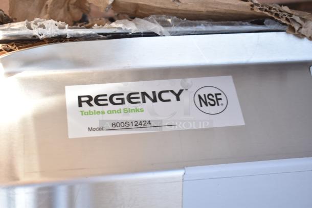 Regency sink with visible tag. Model 600S12424 labeled NSF. New scratch and dent condition. Part of 45-item auction lot.