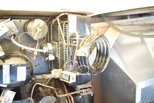 Two Tecumseh compressors, 208-230V, 1-phase, shown with wiring and components, includes visible labels and tags.