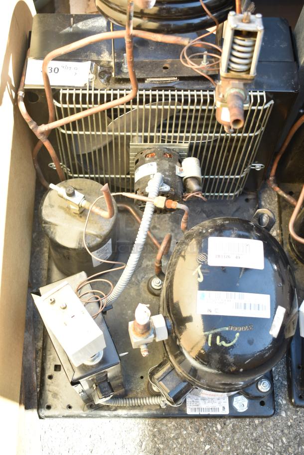 Two Tecumseh compressors, 208-230 volts, 1 phase. Includes coils, wiring, and labels. Good condition.