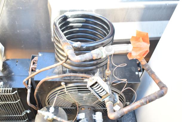Two Tecumseh compressors, 208-230 volts, 1 phase, with copper tubing and black coilwork; slight rust visible.