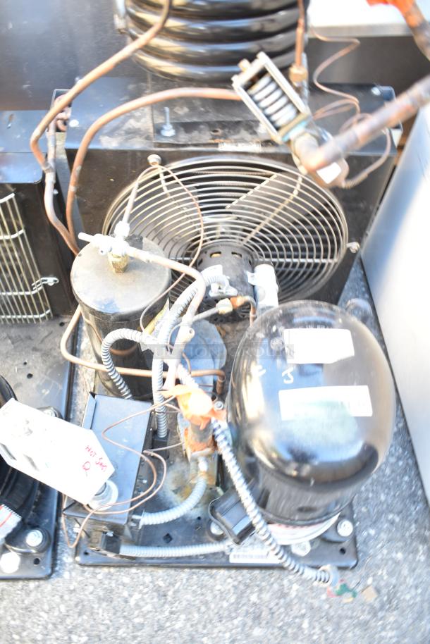 Two Tecumseh compressors, 208-230 volts, 1 phase, shown with connectors and wiring. Used condition.