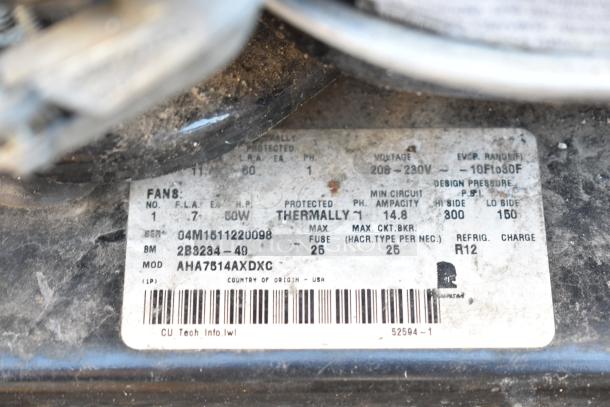 Label on Tecumseh compressor, model AHA7814AXDXC. Voltage: 208-230V, phase: 1, R12 refrigerant, made in USA.