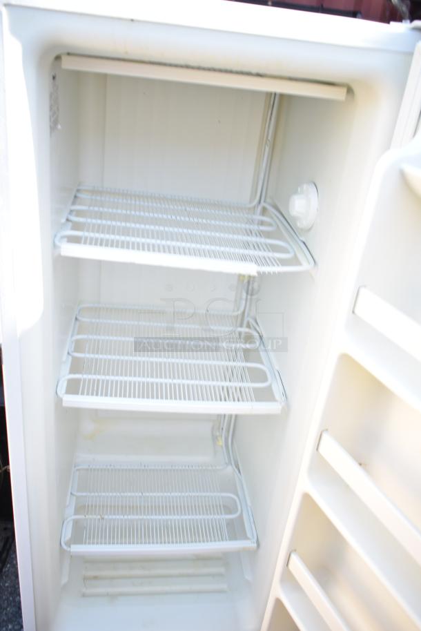 Wood's V07NAA single door reach-in freezer, 115 volts, 1 phase, features three wire shelves, good condition.
