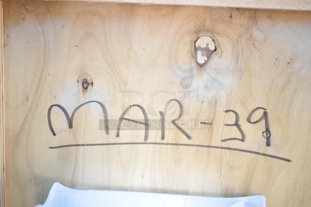 Wooden surface with the text "MAR-39" written in black marker.