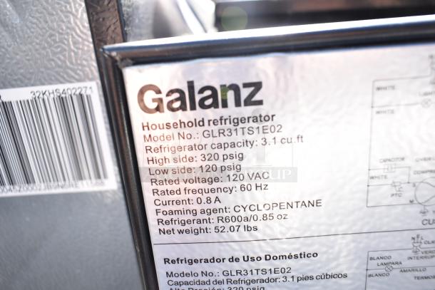 Close-up of a Galanz GLR31TS1E02 mini cooler label detailing 3.1 cu. ft. capacity, 120 VAC, and 52.07 lbs weight.