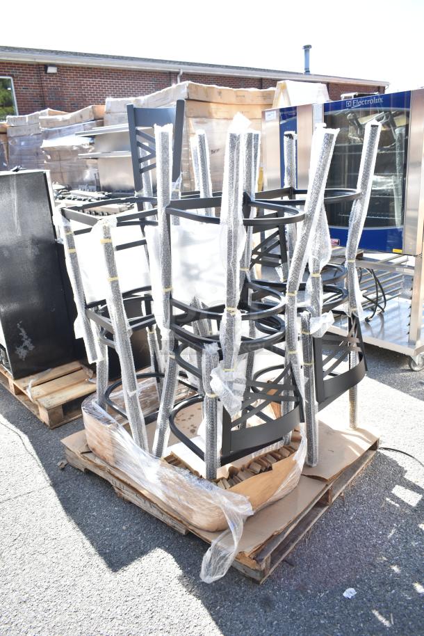 8 new Lancaster Table & Seating black ladder chair frames on a pallet, wrapped in protective packaging.