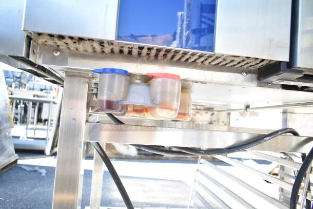 Electrolux Air-o-convect Touchline 9F92225200 convection oven base with blue and red capped containers, on a metal stand with casters.