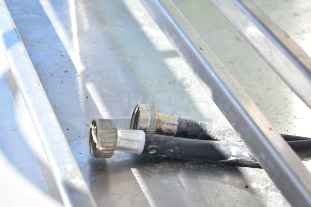 Close-up of metal hoses on Electrolux Air-o-convect oven stand. Partial view of model 9F92225200. Appears in used condition.