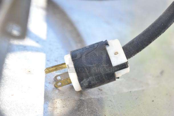 Close-up of a black and white power plug, possibly part of the Electrolux Air-o-convect Touchline oven.